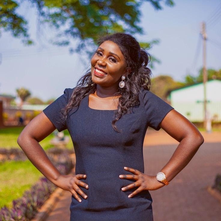 Avery Chen, Lead Design Curator at MeadowPlumeBird, reviewing corporate floral arrangements